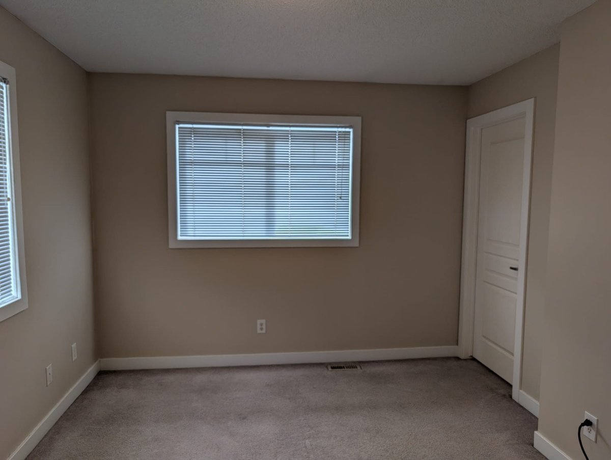 Freshly painted bedroom with bay window by Royal Surface Painting, Calgary